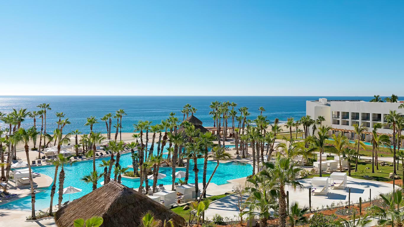 A photo of the Paradisus Los Cabos hotel and pool with ocean in the background